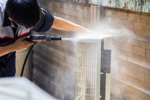 Repairman washing dirty compartments air conditioner, Male techn